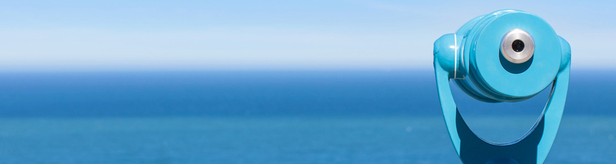 panorama of binoculars and ocean in the background